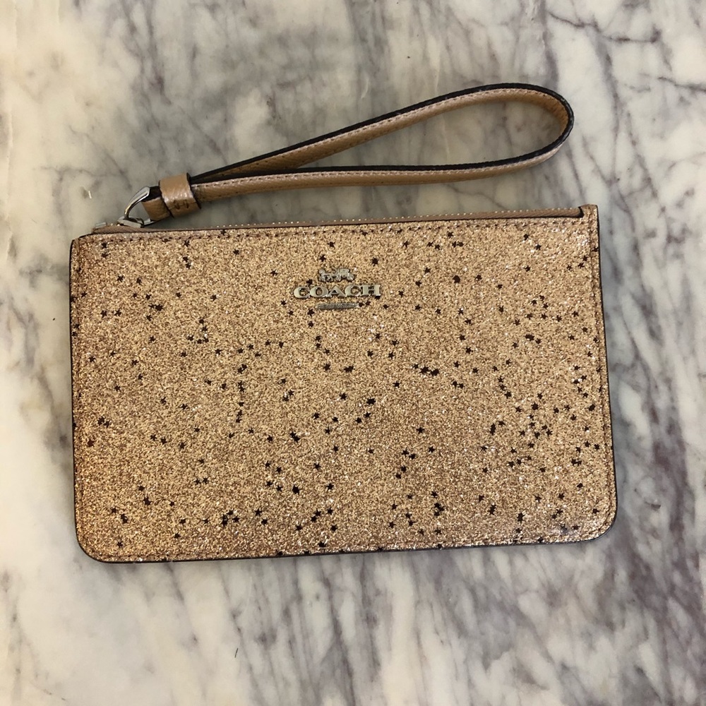 Small gold sparkly coach clutch